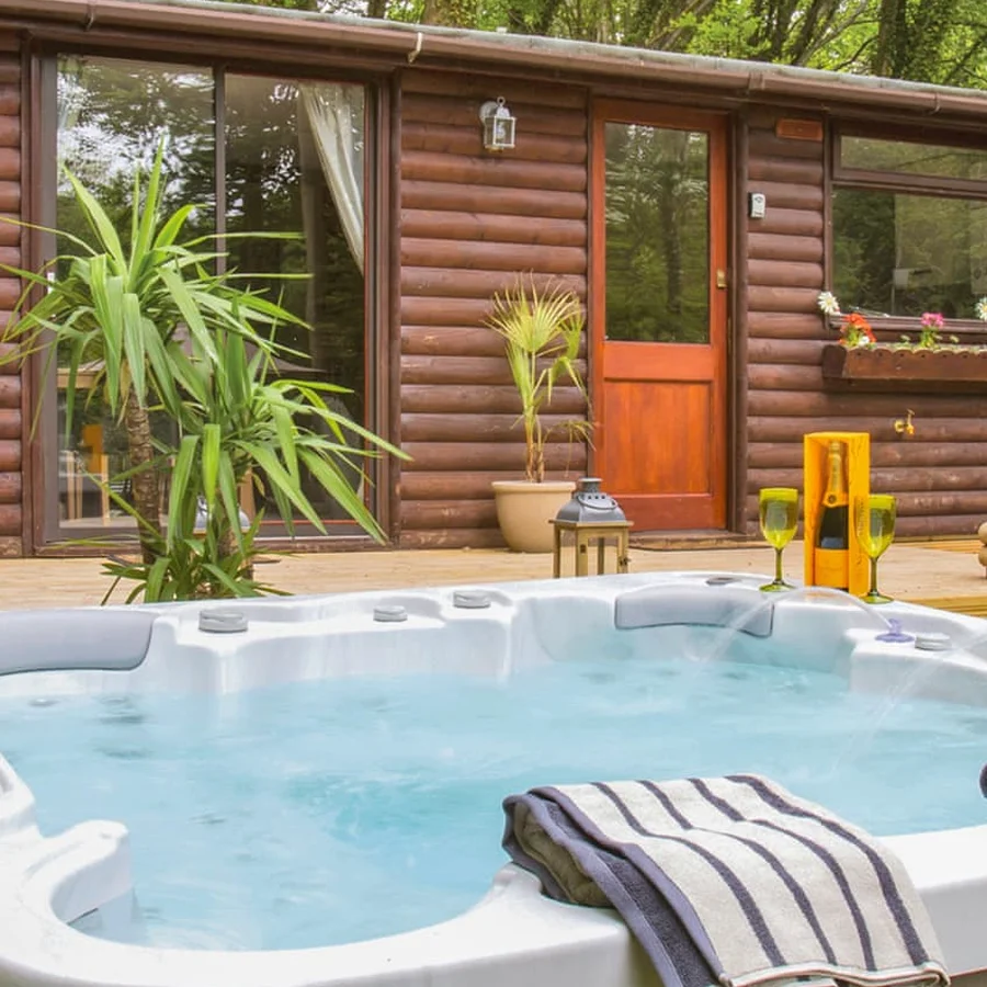 Private hot tub on the decking of a lodge at Herons Lake Retreat